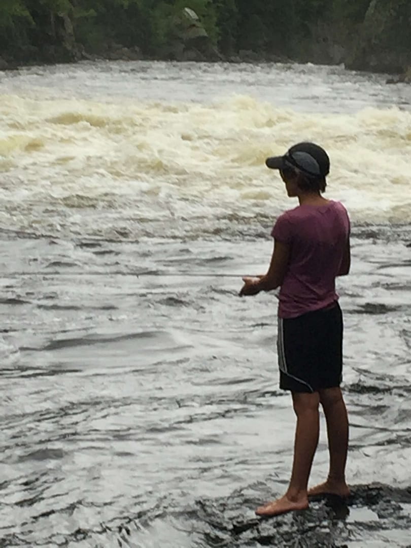 Kid learning how to fly fish